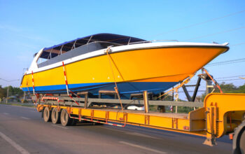 A boat is being loaded on the trailer.