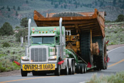 A large truck is pulling a trailer on the road.