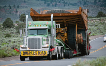 A large truck is pulling a trailer on the road.