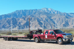 A red truck with a trailer attached to it