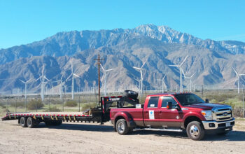 A red truck with a trailer attached to it