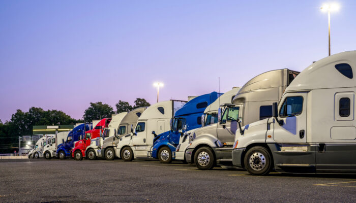 Line,Of,Different,Big,Rigs,Semi,Trucks,Standing,In,Row